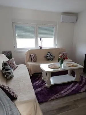 a living room with a couch and a table at Volijak 18 in Jajce