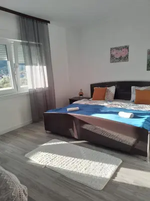 a bedroom with a large bed and a window at Volijak 18 in Jajce