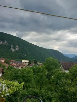 a view of a mountain with houses and trees at Volijak 18 in Jajce