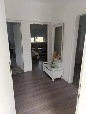 an empty living room with a table and a mirror at Volijak 18 in Jajce