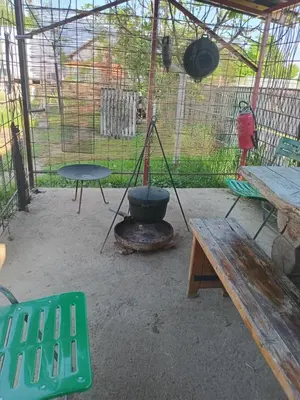 a patio with a pot on a stove and a picnic table at Apartmani Primus in Bosanska Gradiška