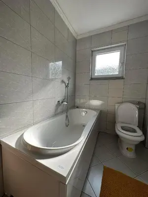 a white bathroom with a tub and a toilet at Apartment Riverstone Retreat in Jajce