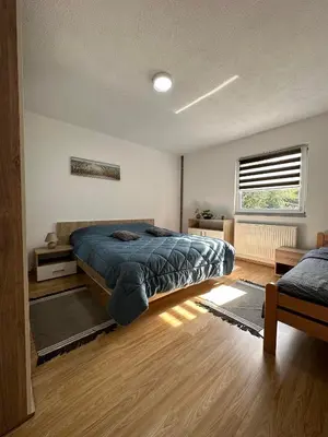 a bedroom with a large bed and a window at Apartment Riverstone Retreat in Jajce
