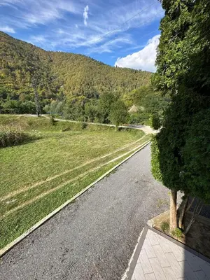 an empty road in the middle of a field at Apartment Riverstone Retreat in Jajce