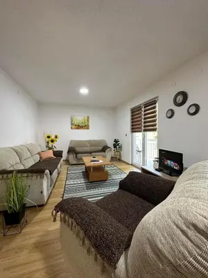 a living room with a couch and a table at Apartment Riverstone Retreat in Jajce