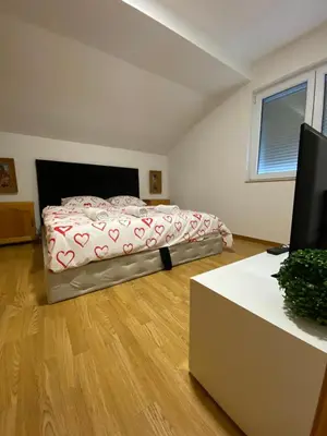 a bedroom with a bed and a desk with a television at Rok in Tešanj
