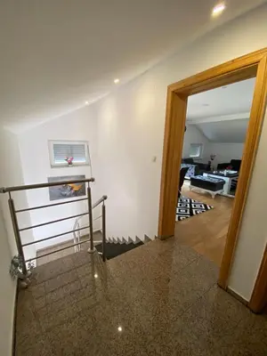 a hallway with a stairway leading to a living room at Rok in Tešanj
