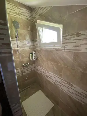 a bathroom with a shower and a window at Rok in Tešanj