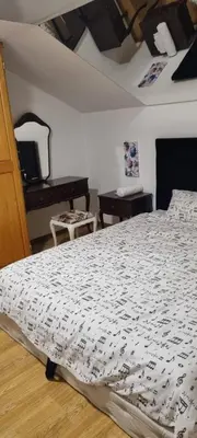 a bedroom with a bed with a black and white comforter at Rok in Tešanj