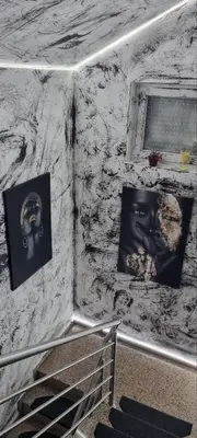 a stone wall with pictures on it with a staircase at Rok in Tešanj