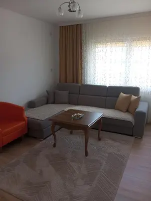 a living room with a couch and a coffee table at Apartmani Mušinbegović1 in Visoko