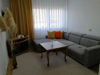a living room with a couch and a coffee table at Apartmani Mušinbegović1 in Visoko