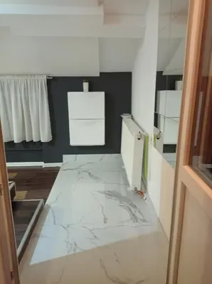 a room with a marble floor with a white refrigerator at DAMI 2 in Tuzla
