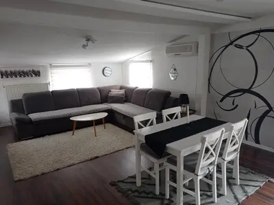 a living room with a couch and a table at DAMI 2 in Tuzla