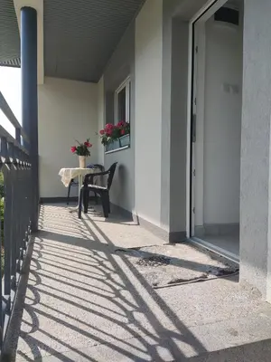 a table and a chair on a porch at Apartman Mir in Visoko