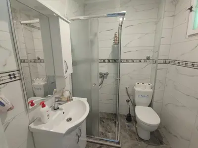 a bathroom with a shower and a toilet and a sink at Apartman Mir in Visoko