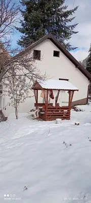a gazebo in the snow in front of a house at Vareš in Vareš