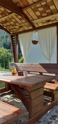 a wooden picnic table under a wooden roof at Vareš in Vareš