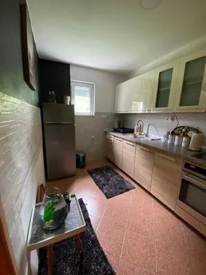 a kitchen with a refrigerator and a table in it at Barok in Tešanj
