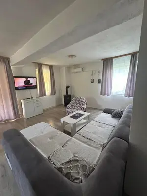 a living room with a couch and a tv at Un Rio Sana in Gornji Ribnik