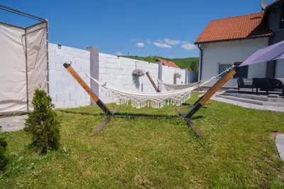 a hammock in the grass in a yard at Sarajevo Villa Sunce in Ilijaš