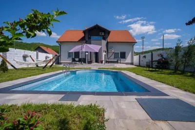 a swimming pool in front of a house at Sarajevo Villa Sunce in Ilijaš