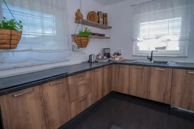 a kitchen with wooden cabinets and a sink at Sarajevo Villa Sunce in Ilijaš