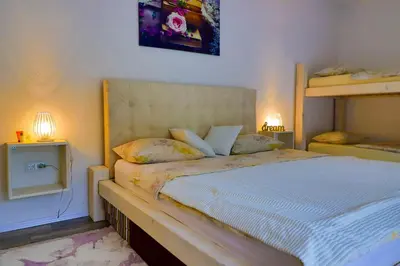 a bedroom with a bed and two bunk beds at Villa Bubinka in Bihać