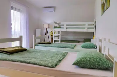a bedroom with two bunk beds and green pillows at Villa Bubinka in Bihać