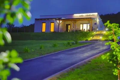 a house with a sign on the side of a road at Villa Bubinka in Bihać