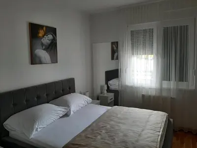 a bedroom with a bed and a window at Apartman Milekic in Banja Luka