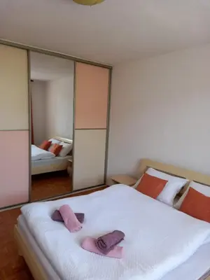 a bedroom with two beds with pink towels on them at TerraNostra in Jajce
