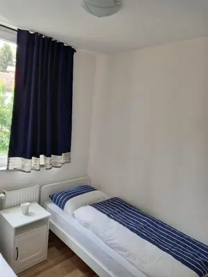 a small bedroom with a bed and a window at TerraNostra in Jajce