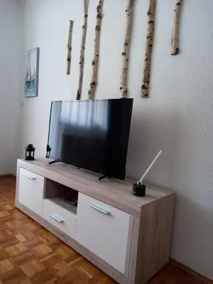 a flat screen tv sitting on top of a wooden entertainment center at TerraNostra in Jajce