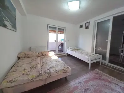 a bedroom with a bed and a window at Apartman Leon in Bihać