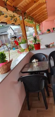 a table and chairs on a counter with plants at Apartman Leon in Bihać