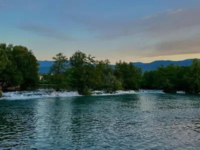a view of a river with trees in the background at Apartman Leon in Bihać