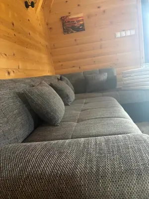 a bed in a room with a wooden wall at Bungalow Jajce 1 in Jezero