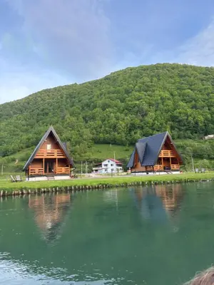 a couple of houses sitting next to a body of water at Bungalow Jajce 2 in Jezero
