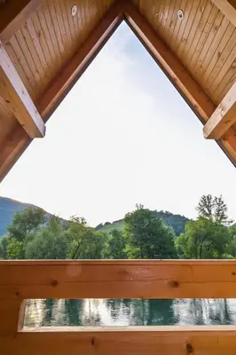 a window in a cabin with a view of the water at Bungalow Jajce 2 in Jezero