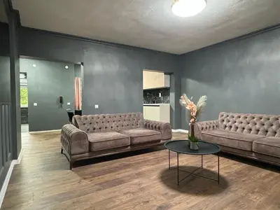 a living room with two couches and a table at Lux apartments Crystal-center in Bihać
