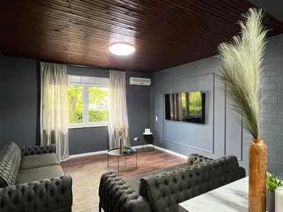 a living room with two couches and a tv at Lux apartments Crystal-center in Bihać