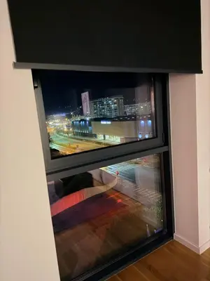 a window with a view of a city at night at Smart Loft Apartment - connection of city center and luxury in Tuzla