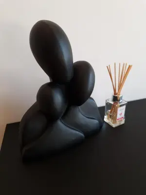a stack of black balloons sitting on a table with a bottle at Smart Loft Apartment - connection of city center and luxury in Tuzla