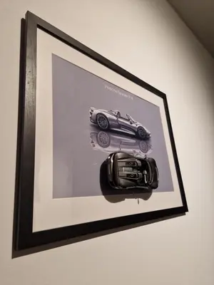 a picture of a car in a frame on a wall at Smart Loft Apartment - connection of city center and luxury in Tuzla