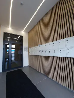 an empty office with a wall with lockers and a door at Smart Loft Apartment - connection of city center and luxury in Tuzla