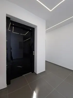 an empty room with a black door and a white wall at Smart Loft Apartment - connection of city center and luxury in Tuzla