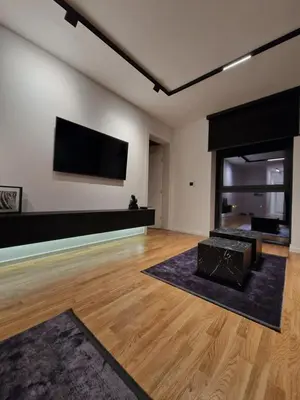 a living room with a fireplace and a flat screen tv at Smart Loft Apartment - connection of city center and luxury in Tuzla