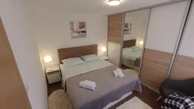 a bedroom with a bed with two towels on it at New apartment - Moon in Banja Luka