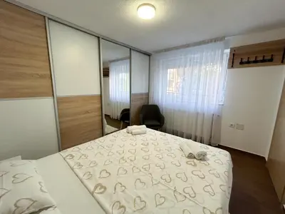 a bedroom with a bed and a large mirror at New apartment - Moon in Banja Luka